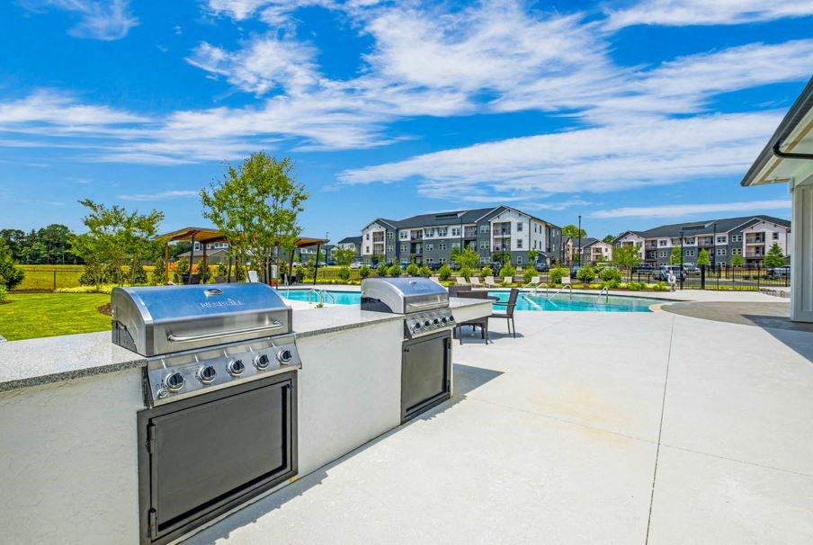 Downtown Greenville Apartments - The Aster - Poolside Grill Area with Two BBQ’s, Counterspace, and Seating Area.
