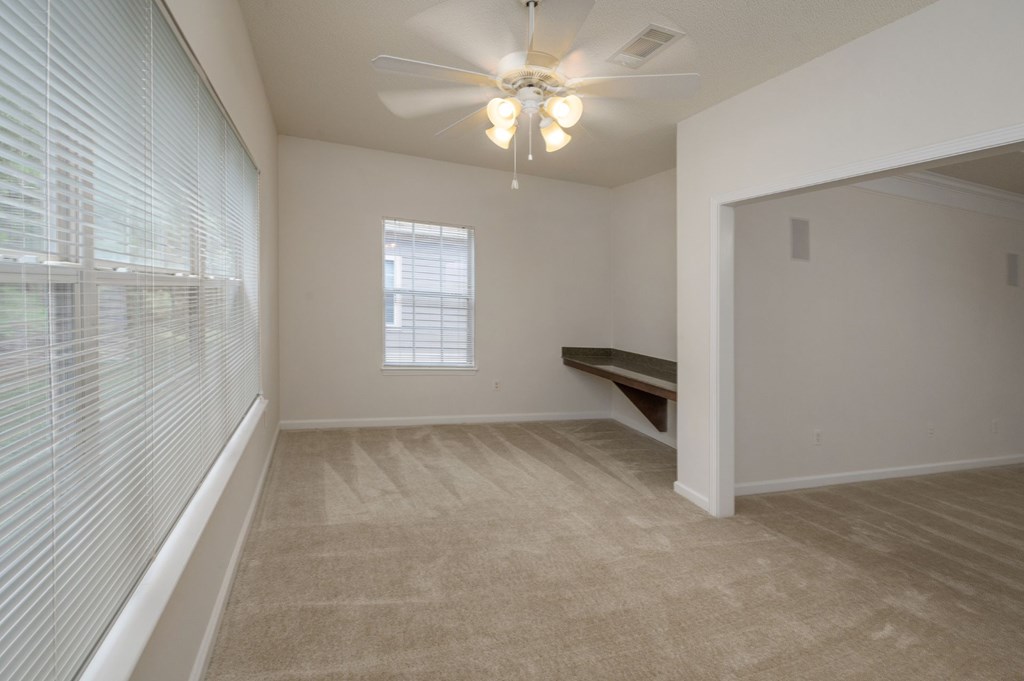 A room with a window and a bench.