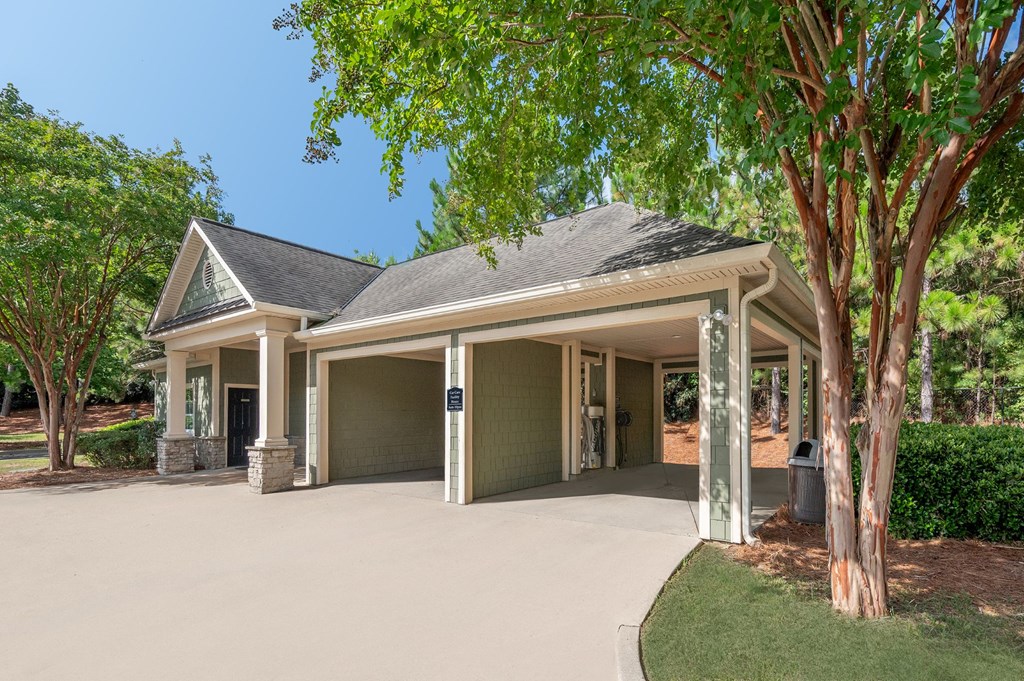 A house with a grey roof and a garage door.