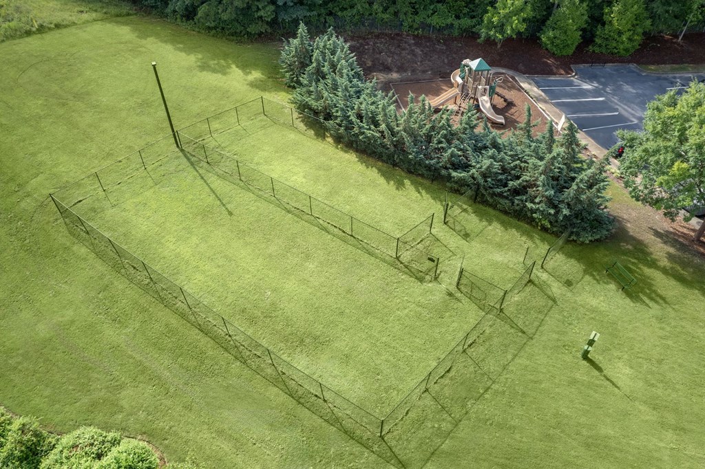 A large open grassy area with a maze in the middle.