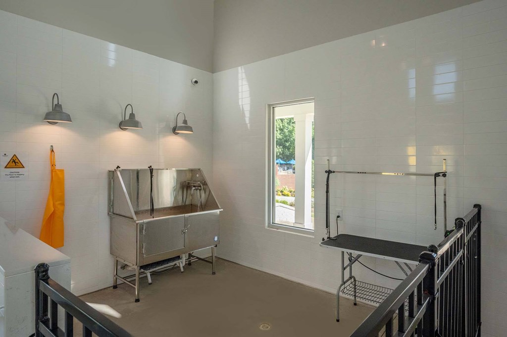 A kitchen area with a stainless steel sink and a window.