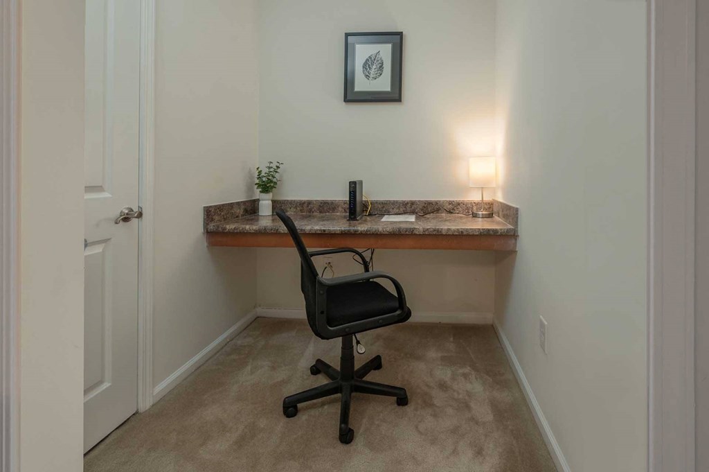 A small room with a desk and a chair.