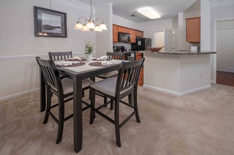 A dining room with a table set for four.