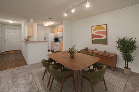 A dining room with a wooden table and green chairs.