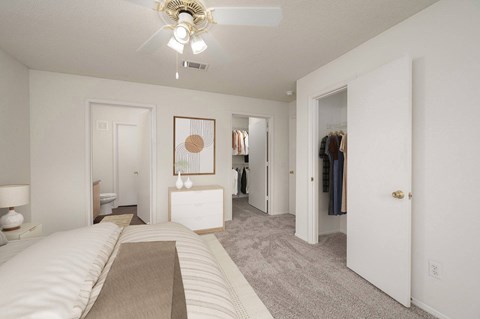 A bedroom with a large bed and a closet.