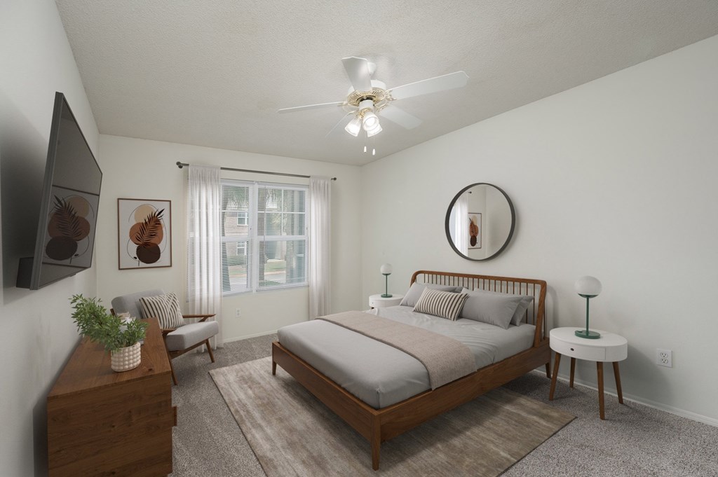 A bedroom with a bed, nightstand, and a ceiling fan.