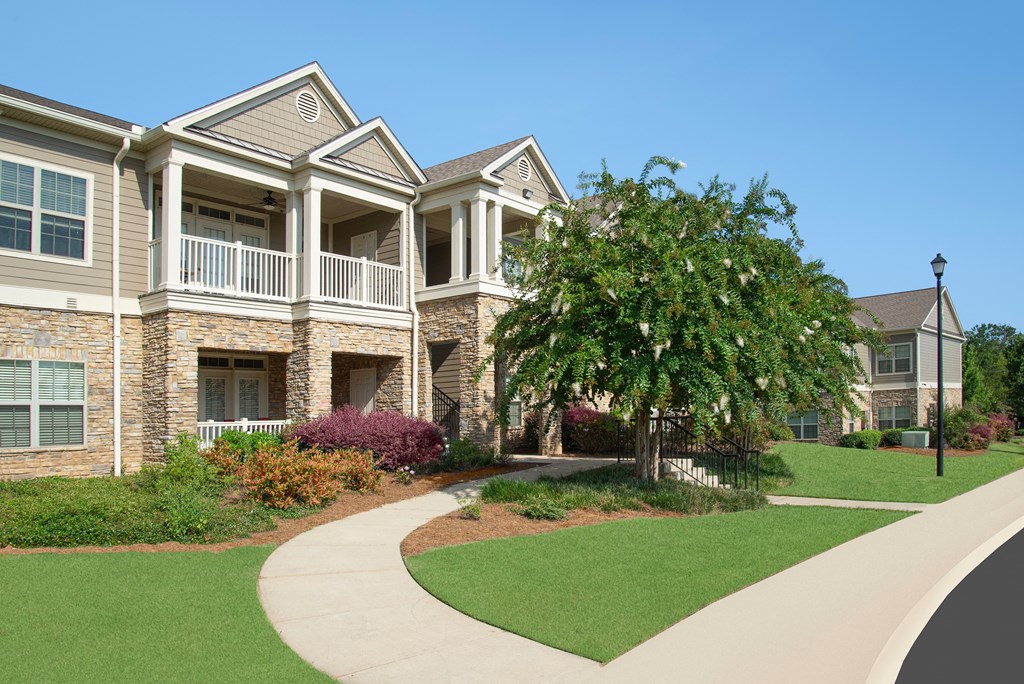 an image of a walkway in front of an apartment building
