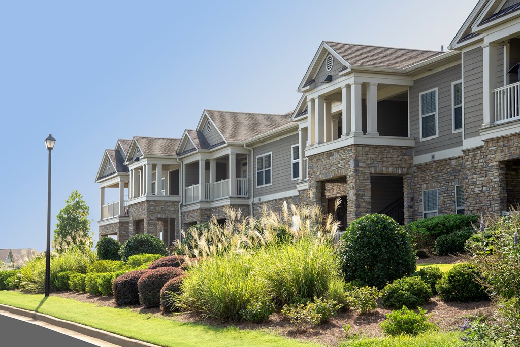 a row of houses with landscaping in front of them