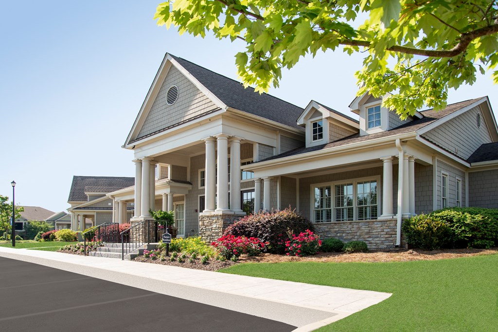a large house with a sidewalk in front of it