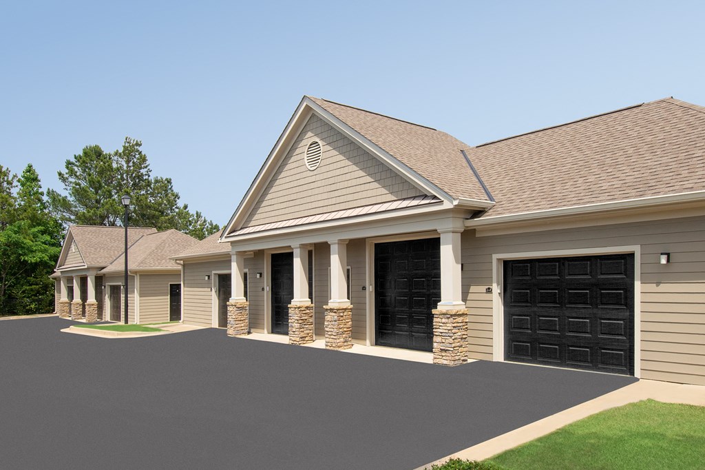 a front view of a house with black garage doors