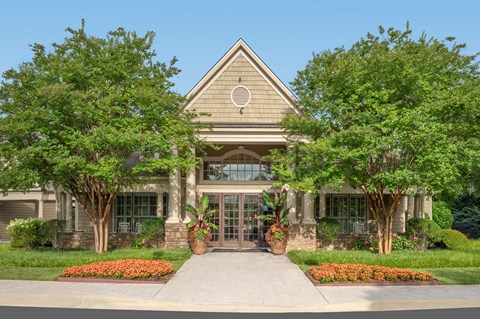 A building with a triangular roof and a circular logo on it.