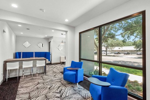A conference room with a long table and chairs.