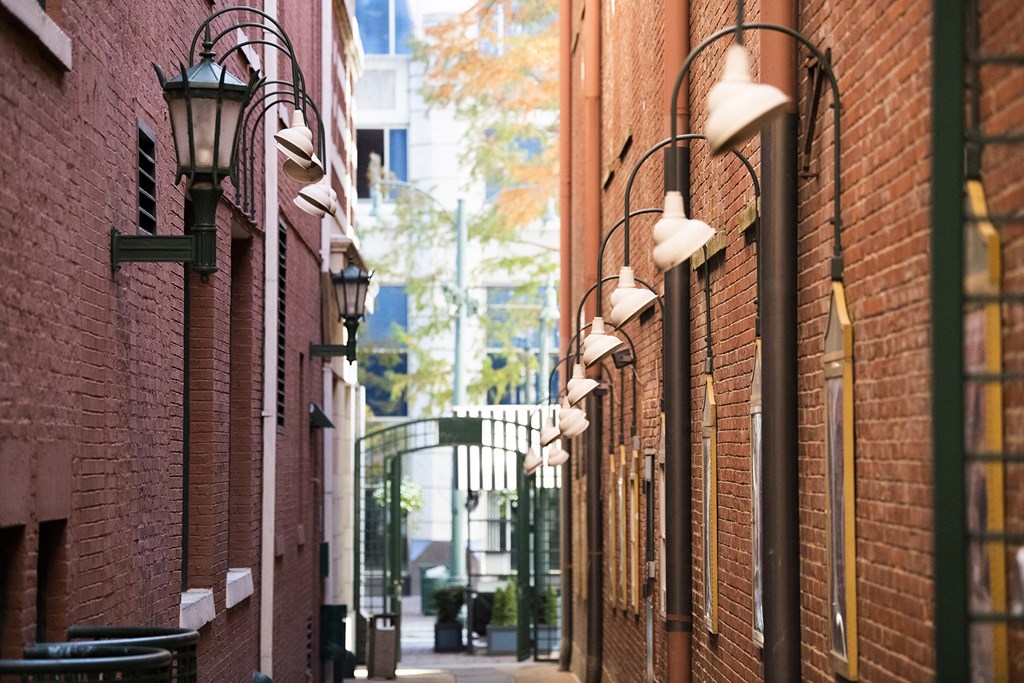 a city street with red brick buildings and street lights