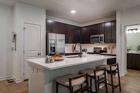 A kitchen with brown cabinets and white countertops.