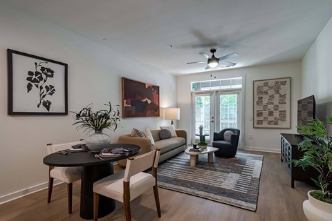 A living room with a dining table and chairs.