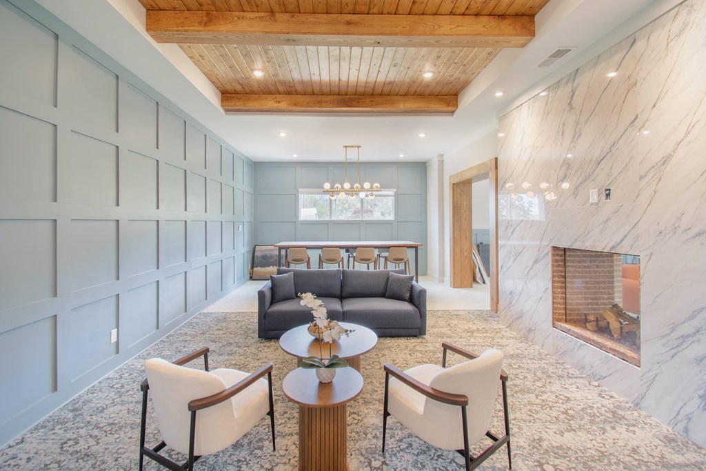 a living room with couches and chairs and a fireplace