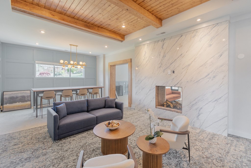 a living room with a couch and tables and a fireplace