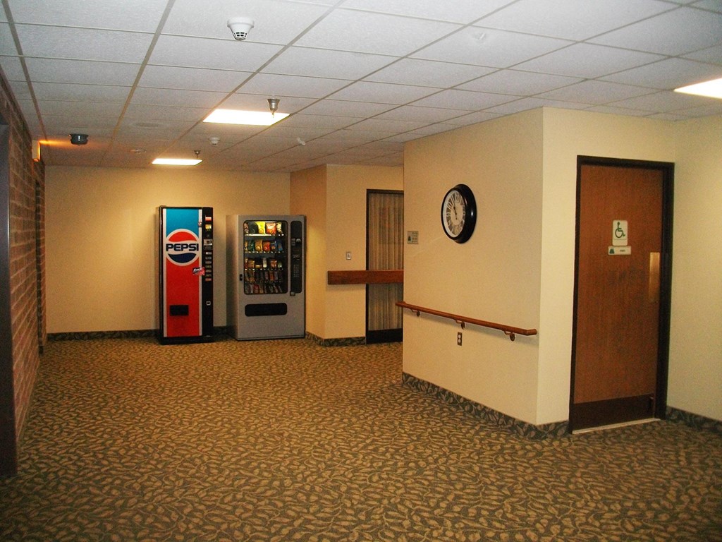 a room with two vending machines in the corner of a room