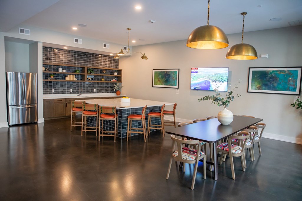 A modern kitchen with a dining table and chairs.