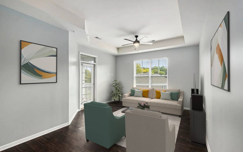 A living room with a green chair and a white couch.