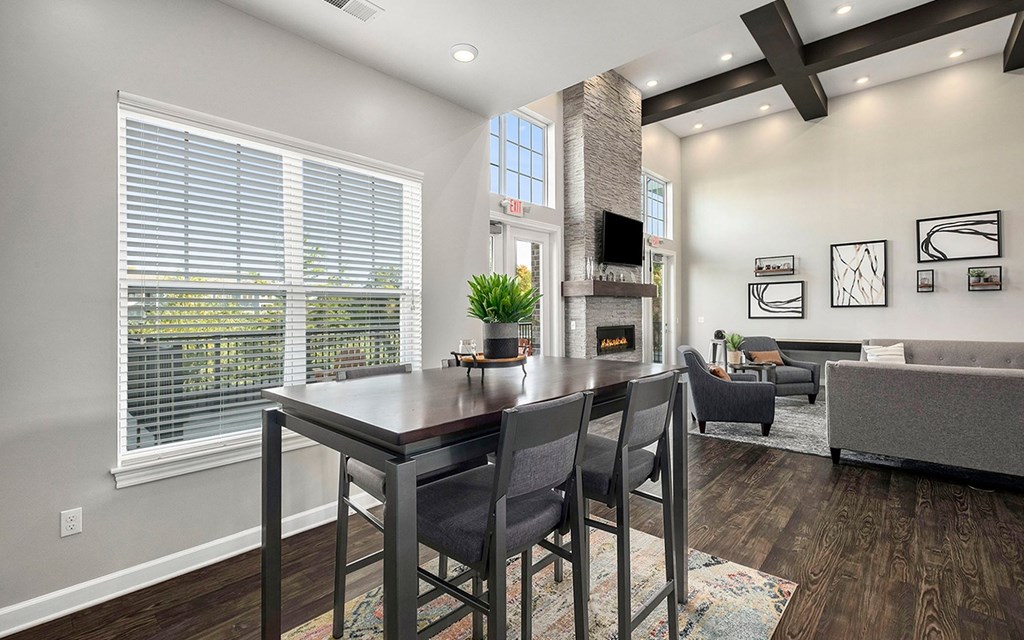 A modern dining room with a wooden table and chairs.