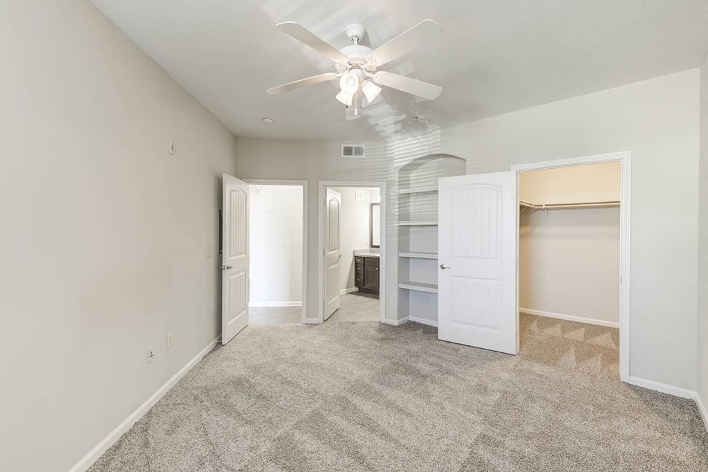 Three Bedroom Apartments in Lewisville TX - Hebron 121 Station - Cozy Bedroom with Carpeted Flooring, Built-In Shelves, and Large Closet