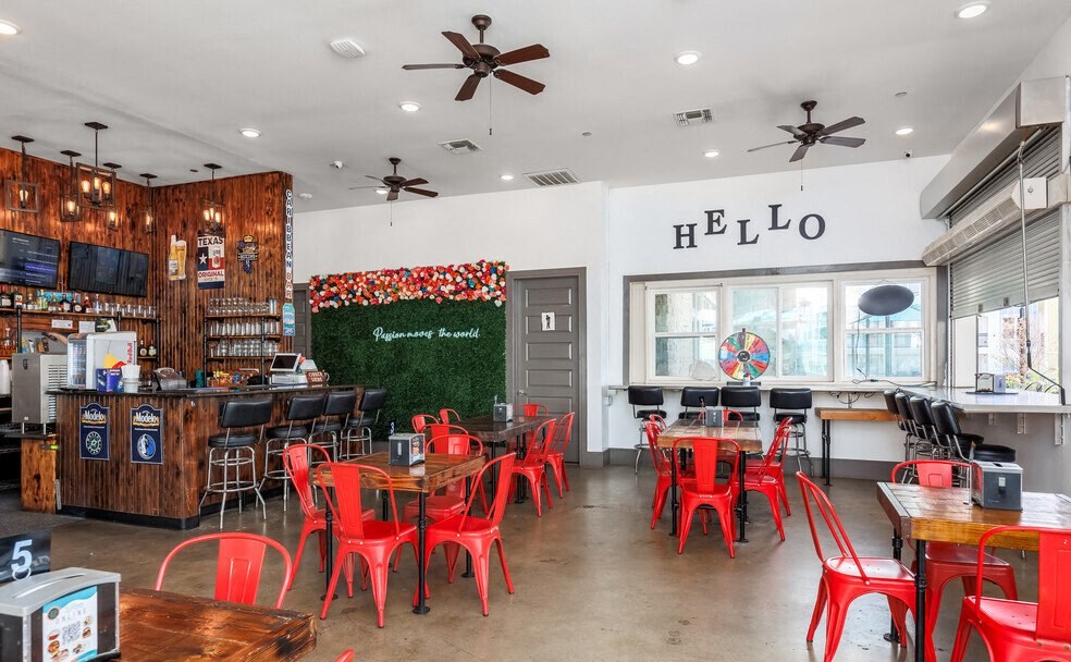 a restaurant with red chairs and tables and a bar