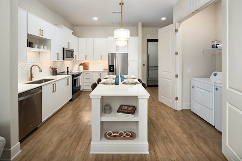 a kitchen with white cabinets and a white island