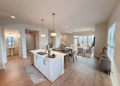 a kitchen and living room with a dining area and a living room