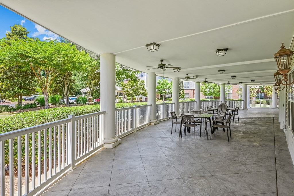 a covered patio with tables and chairs on it