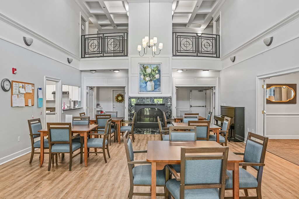 a large dining room with tables and chairs and a fireplace