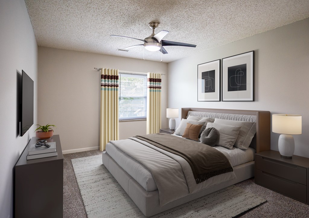 A bedroom with a large bed, a ceiling fan, and two lamps.