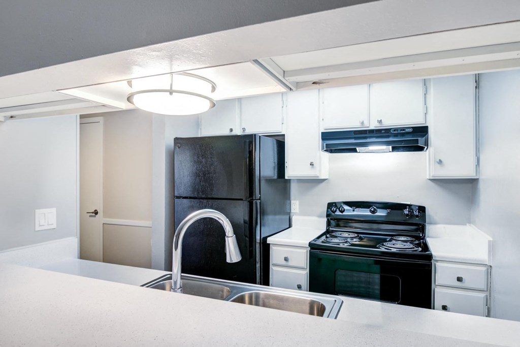 a kitchen with a sink and a refrigerator