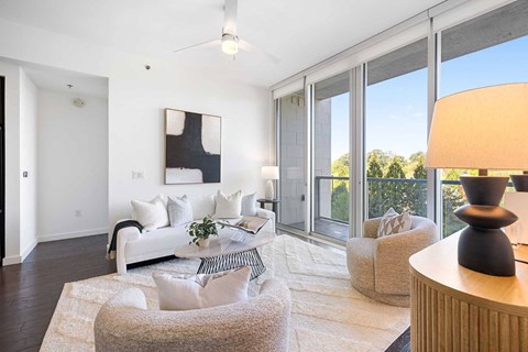 A living room with a white couch and a grey armchair.