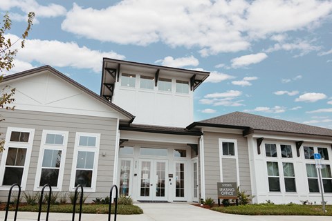 a large white house with a sign in front of it