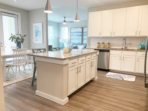 a large kitchen with white cabinets and a counter top