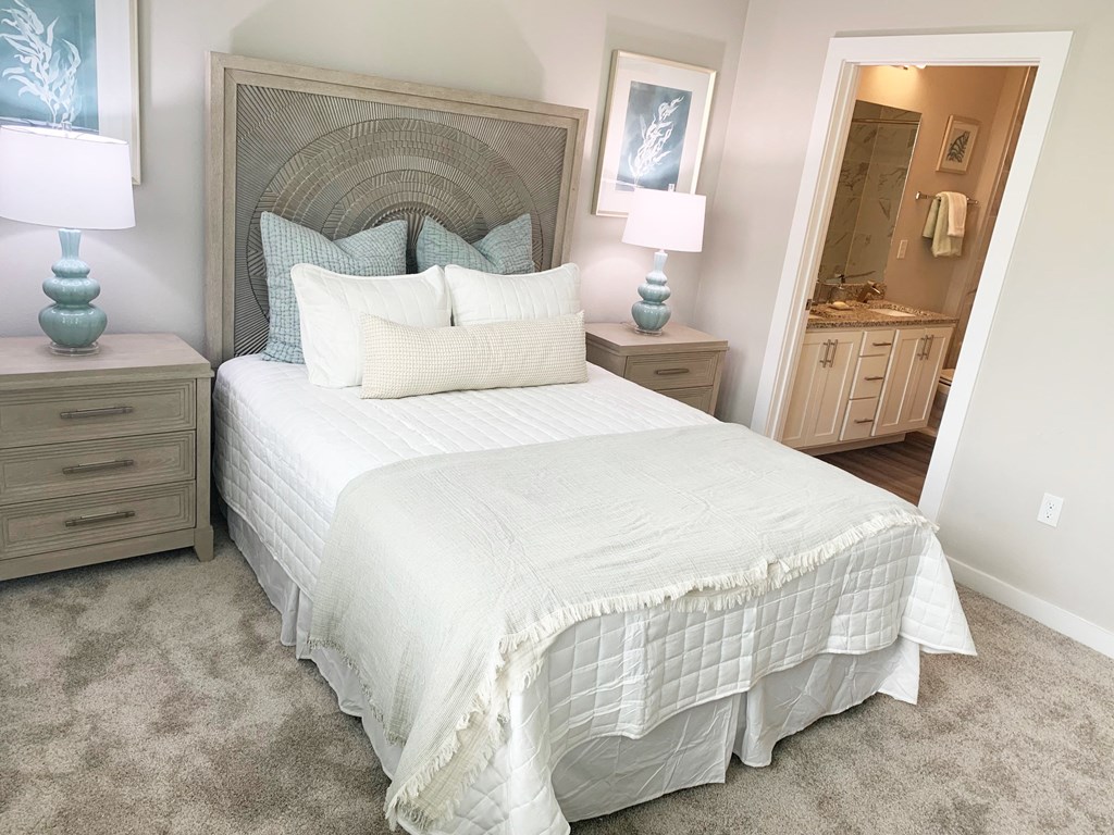 a bedroom with a large bed and two night stands