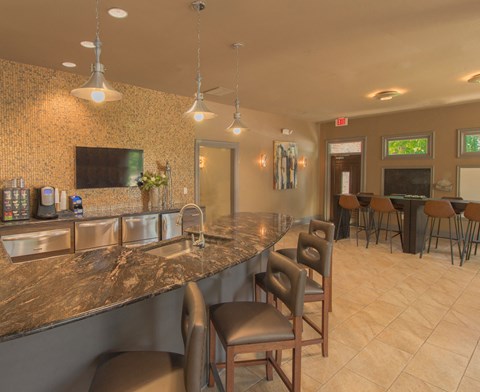 a kitchen with a marble counter top and bar stools