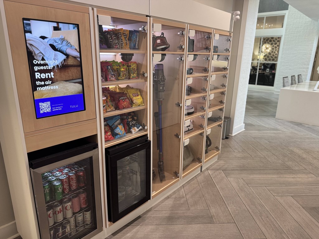 A vending machine with a screen advertising overnight guest rentals.