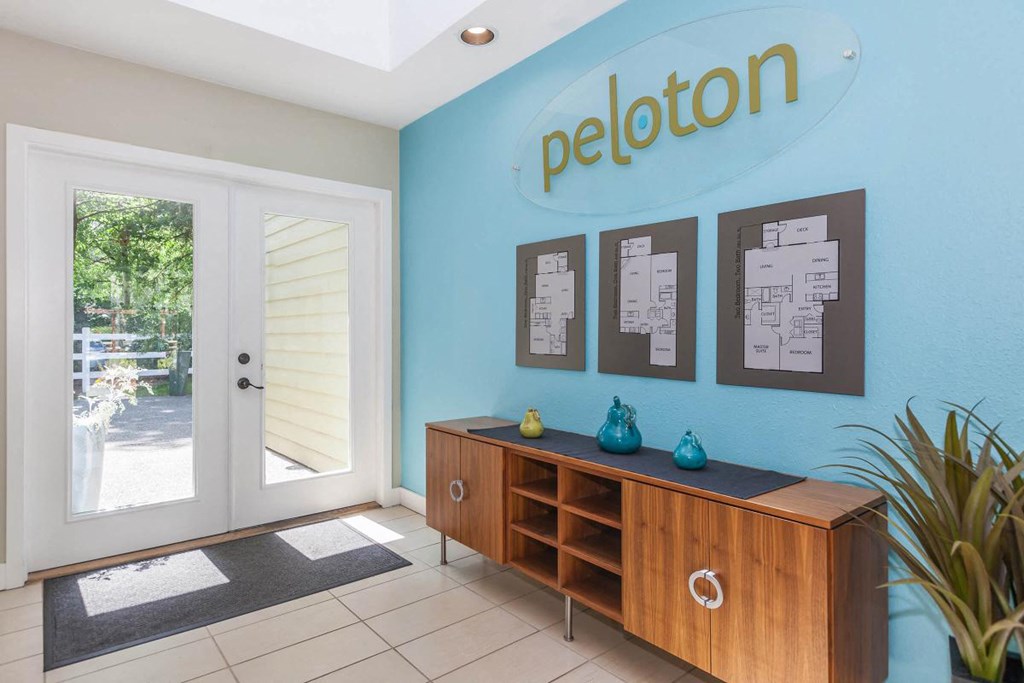 a room with a blue wall and a door that says peleton