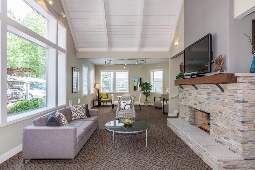 a living room with couches a coffee table and a fireplace