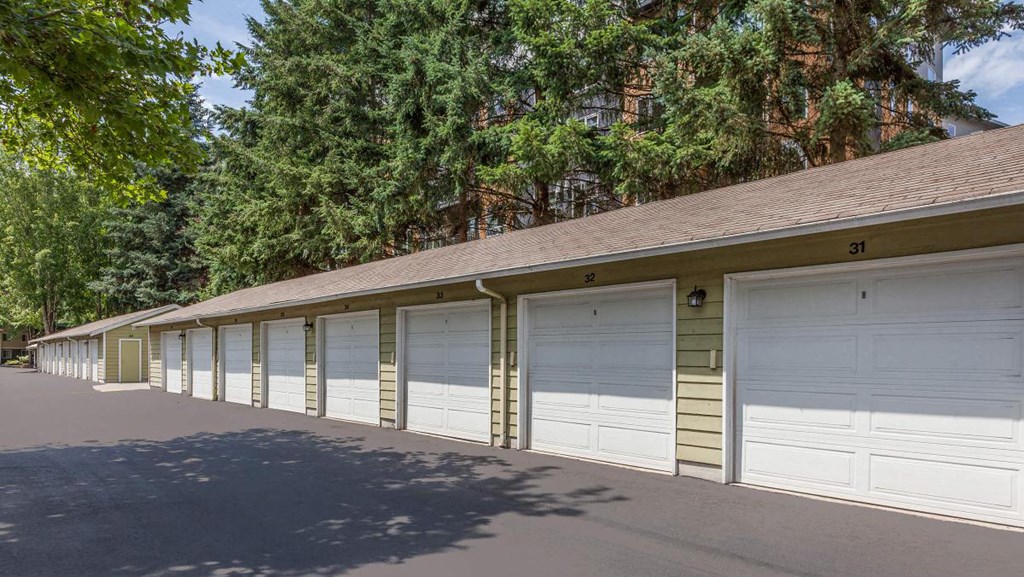 a row of garages in a row with trees in the background