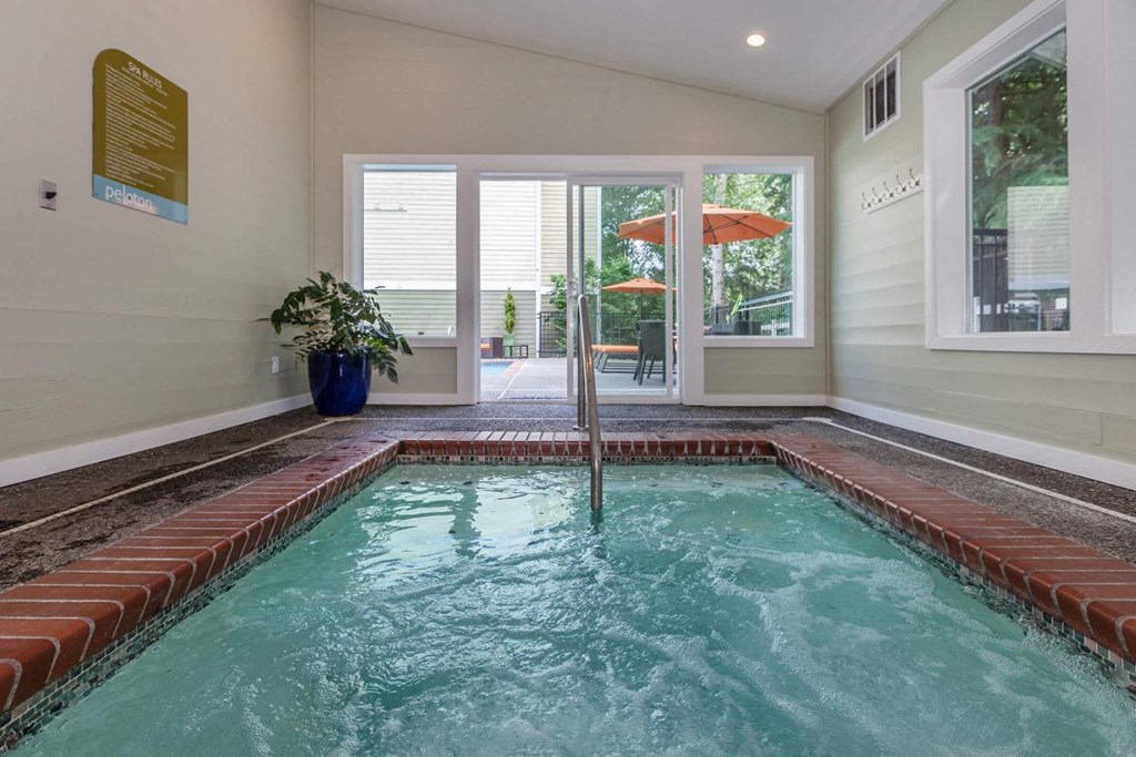 a home with an indoor pool and an open door