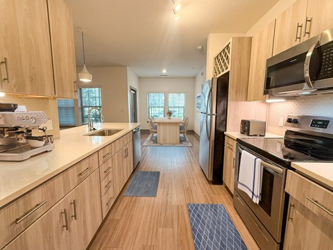 A kitchen with wooden cabinets and a white countertop.