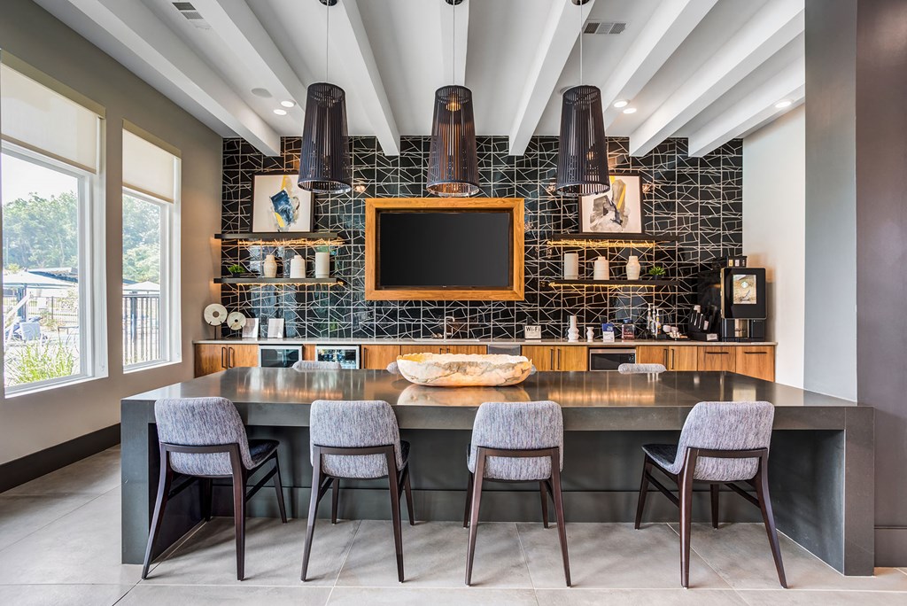 a kitchen with a table and chairs and a television