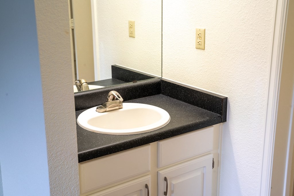 a sink in a bathroom with a mirror above it