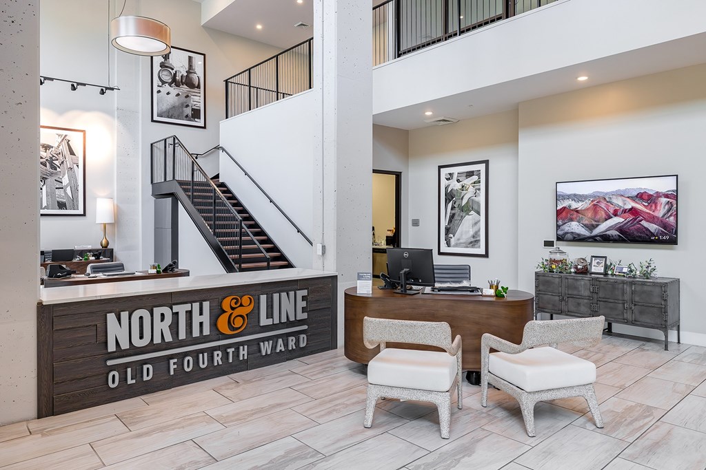 A reception area with a desk and chairs in front of a sign that says "North & Line Old Fourth Ward".
