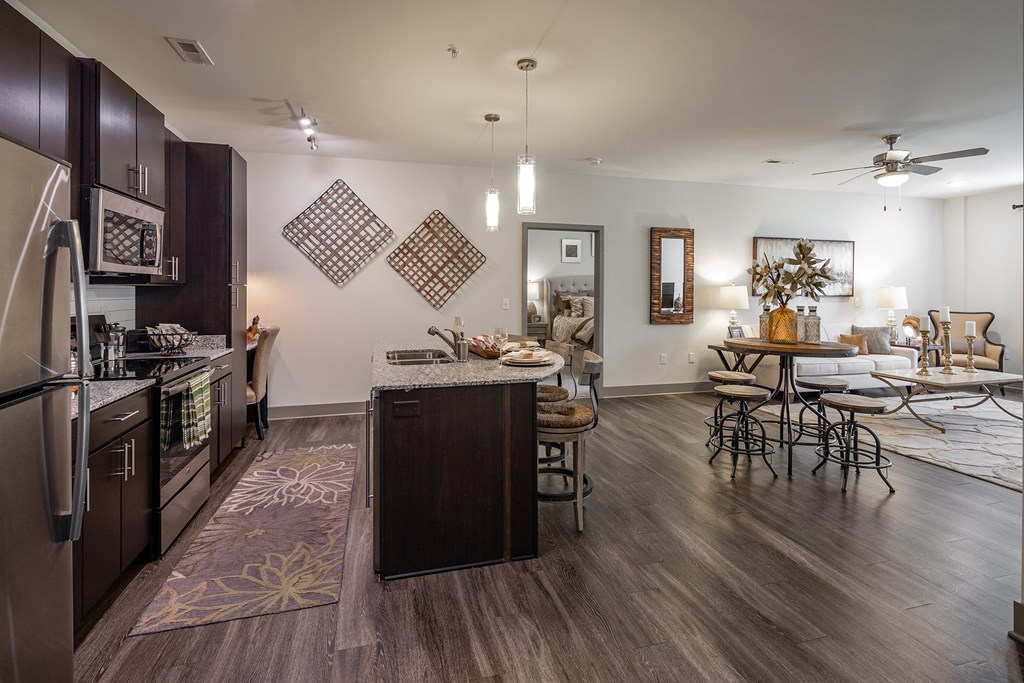a kitchen and living room with a dining area and a table with chairs