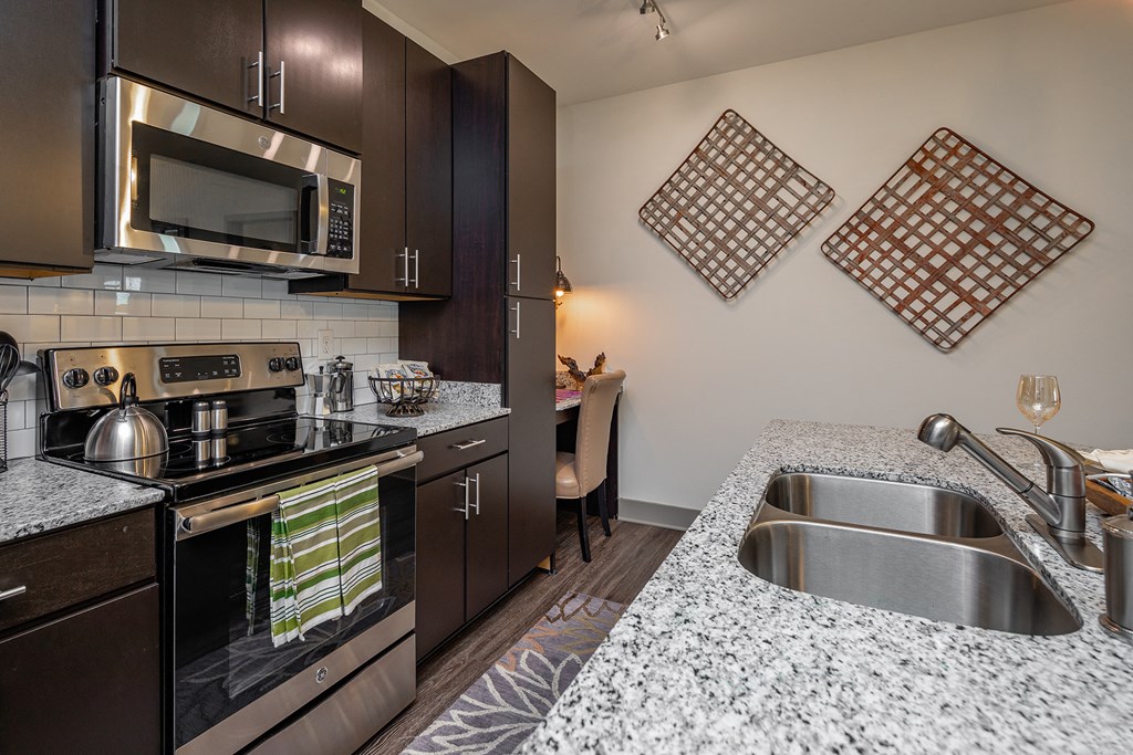 kitchen with granite counter tops and stainless steel appliances at the reserve at walnut creek