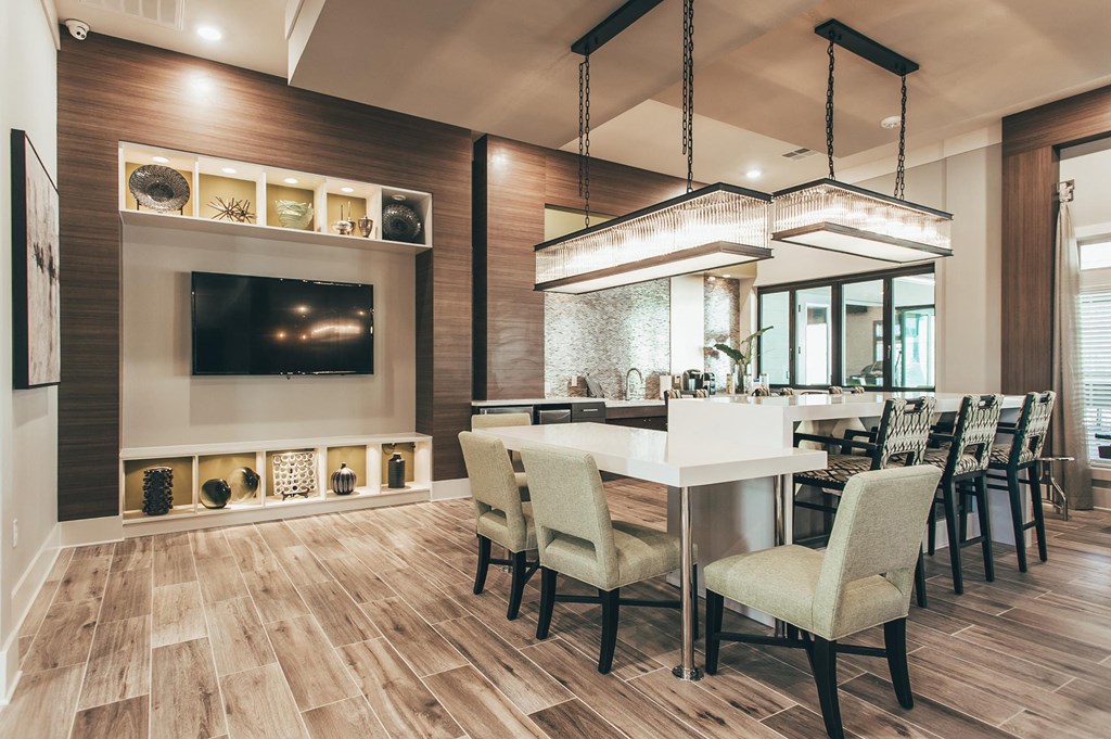 a dining room with a table and chairs and a tv